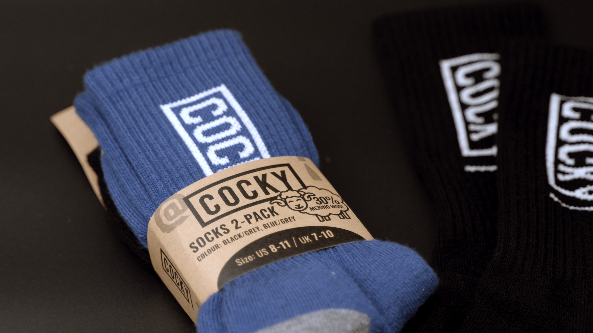 cocky socks laid flat on black background