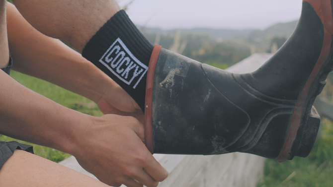 cocky socks, on foot, being put into gumboots